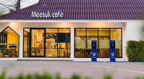 a mexican cafe with large windows and a sign at Meesuk ChiangRai Hotel in Chiang Rai