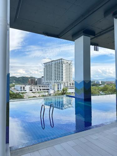 a swimming pool with a view of a building at Deluxe 2BR Seaview and Mountain View with balcony in Kota Kinabalu