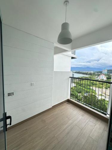 a room with a balcony with a view of the water at Deluxe 2BR Seaview and Mountain View with balcony in Kota Kinabalu