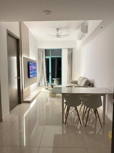 a white living room with a table and chairs at Deluxe 2BR Seaview and Mountain View with balcony in Kota Kinabalu