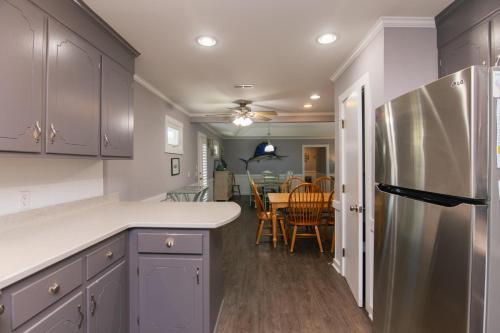 a kitchen with a refrigerator and a dining room at Sutton House in Edisto Island