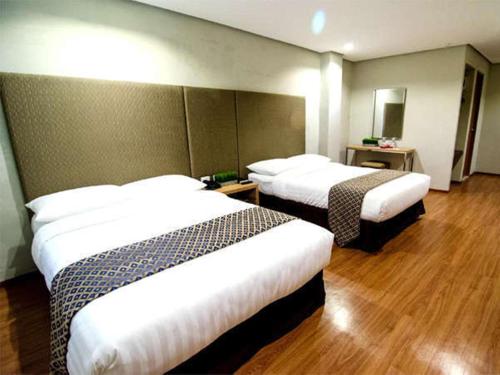 Katil atau katil-katil dalam bilik di Madison Hotel PHL