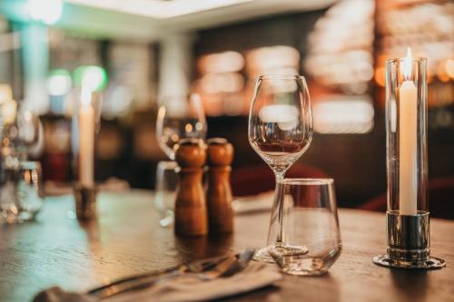 a table with three wine glasses on it at La Maison 20 Degrés Sud - Relais & Châteaux in Grand Baie