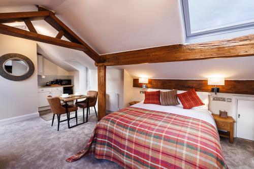 a bedroom with a bed and a table in a room at Westwood Boutique Aparthotel by Birch Stays in Glossop