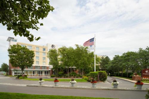 a building with an american flag on a street at DoubleTree by Hilton Hotel Boston Bayside in Boston