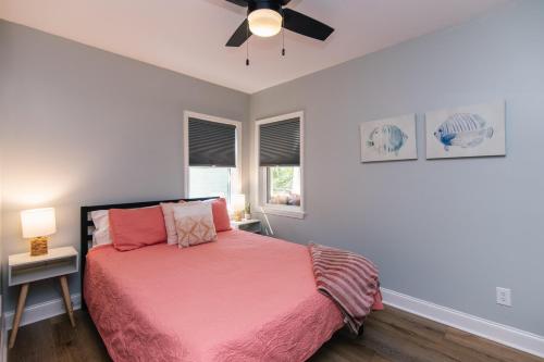 a bedroom with a bed and a ceiling fan at Edisto Echo in Edisto Beach