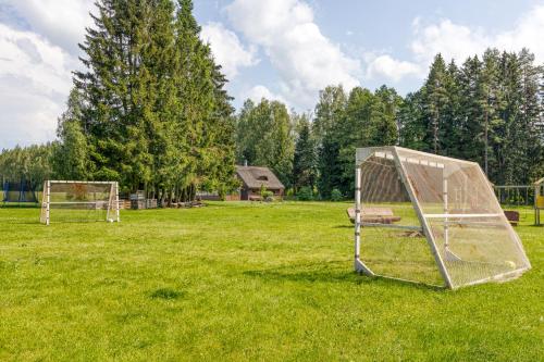 a field with two soccer nets in the grass at Pirts māja Ramatas in Skulte