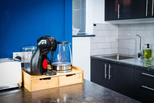 a kitchen counter with a mixer on a wooden stand at The Luxury Canvas by The Hive WA1 in Warrington