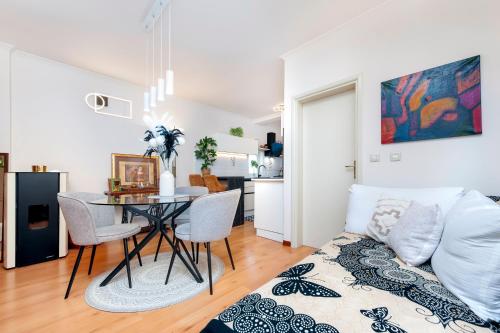 a living room with a table and a couch at Apartment Studio Lara in Rovinj
