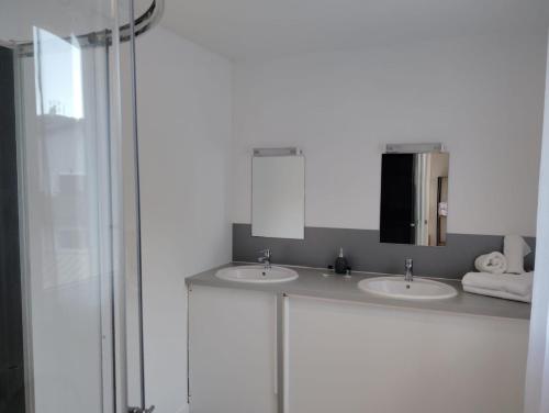 a bathroom with two sinks and a mirror at Ice Rock Hotel in LʼArgentière-la-Bessée