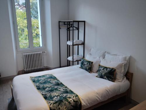 a bedroom with a bed with two pillows at Ice Rock Hotel in LʼArgentière-la-Bessée
