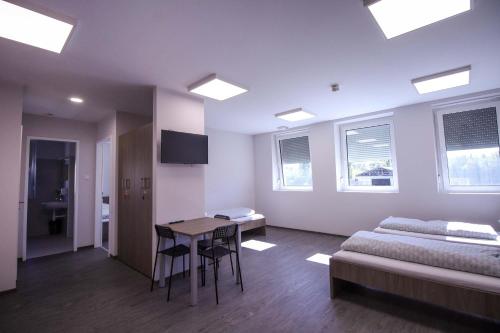 a bedroom with a bed and a table and chairs at Turbo Szálló Kalocsa in Foktő