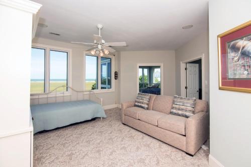 a living room with a couch and a bed at Moonrise Point in Edisto Island