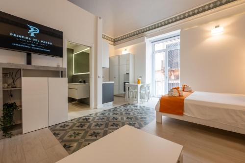 a bedroom with a bed and a tv in a room at Principe del Pardo in Catania