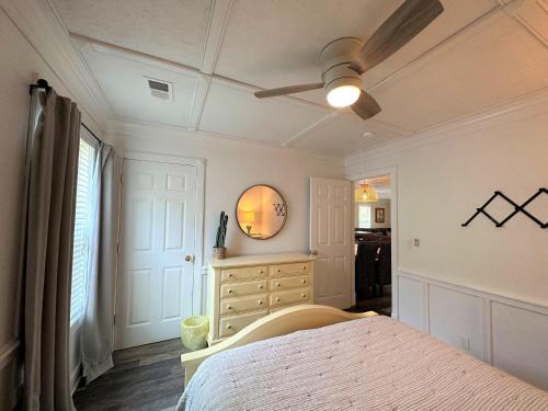 a bedroom with a bed and a ceiling fan at Serenity Now in Edisto Island