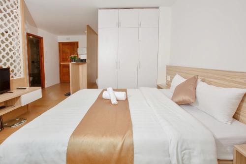 a large white bed with a towel on top of it at Gardenia Hue Hotel in Hue