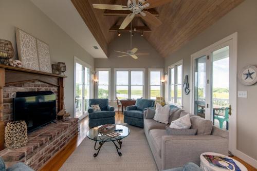 a living room with a couch and a fireplace at Tequila Sunset in Edisto Island
