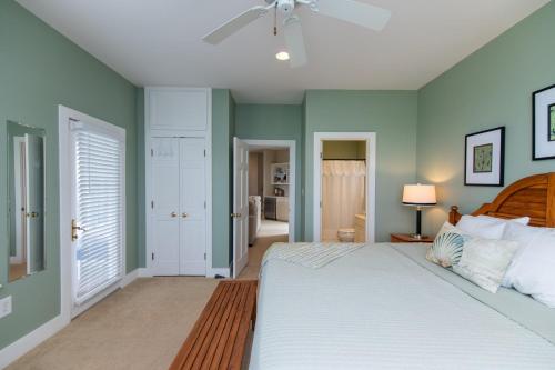 a bedroom with a bed and a ceiling fan at Tequila Sunset in Edisto Island