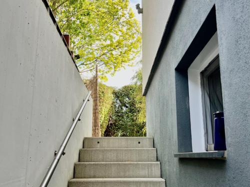 a stairway leading up to a building with a window at Beim Thöny - schönes Apartment mit privatem Zugang in Utting am Ammersee