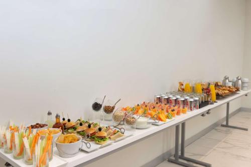 a buffet line with different types of food and drinks at NH Monterrey La Fe in Monterrey