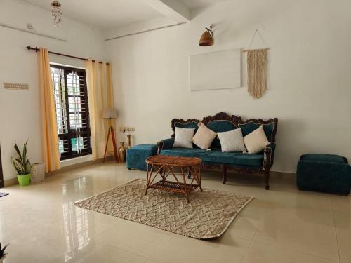 a living room with a couch and a table at Shamak Homestay Varkala in Varkala