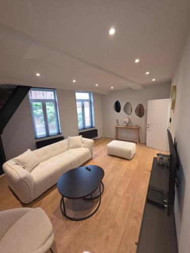 a living room with a couch and a table at First in Tournai