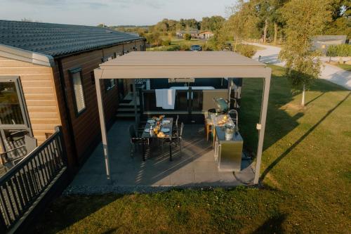 an overhead view of a patio with a white canopy at Landal Angrove in Great Ayton