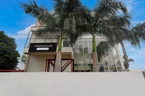 a building with palm trees in front of it at Collection O B.R. Ambedkar Park Taramandal Formerly Shree Krishna Inn in Gorakhpur