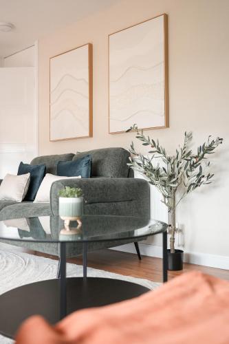 a living room with a couch and a table at Beechgrove House in Livingston