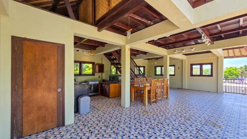 a large room with a kitchen and a dining room at Dalai Tropical in Kuta Lombok