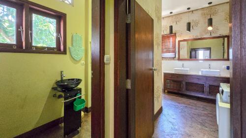 a bathroom with a sink and a mirror at Dalai Tropical in Kuta Lombok