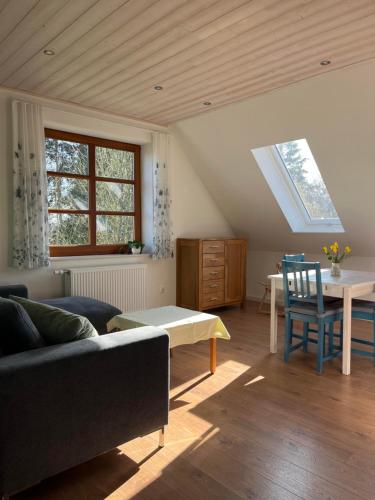a living room with a couch and a table at Ferienwohnung Wiesenblick in Gödenstorf