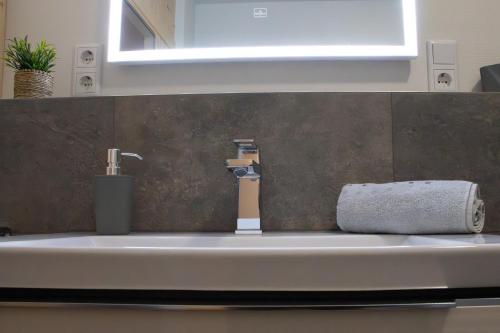 a bathroom sink with a faucet and a towel at Schöne Tiet - Küste33 26 in Tossens