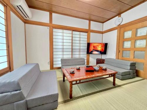 a living room with a couch and a coffee table at Mic HANEDA in Tokyo