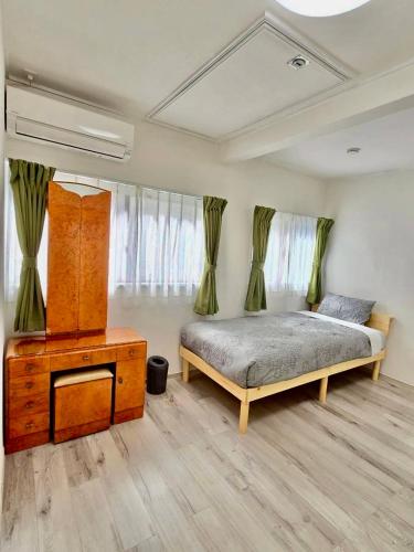 a bedroom with a bed and a dresser in it at Mic HANEDA in Tokyo