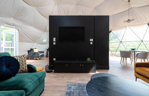 a living room with a couch and a tv in a tent at Landal Angrove in Great Ayton