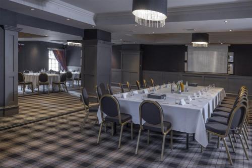 a conference room with a long white table and chairs at Best Western Glasgow South Eglinton Arms Hotel in East Kilbride