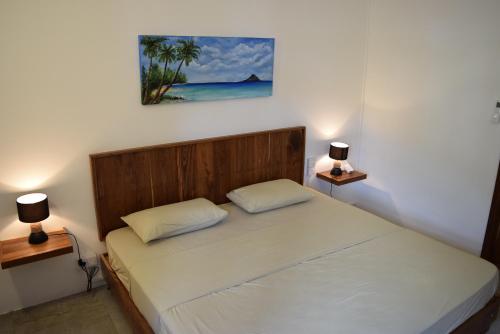 a bedroom with a bed with two lamps on both sides at Mountain View Apartment in La Gaulette