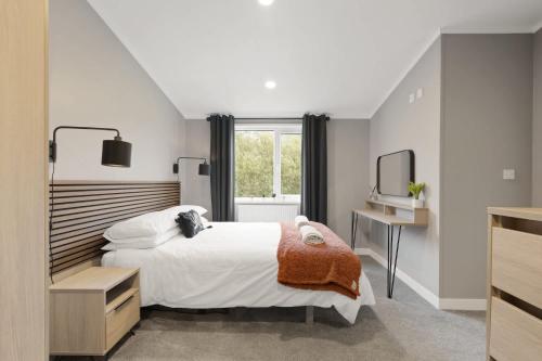 a bedroom with a large bed and a window at Modern Lodge nr Ilfracombe & Beaches in West Down