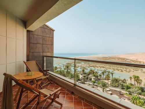 a balcony with a table and a view of the beach at Paradisus by Meliá Fuerteventura - All Inclusive in Costa Calma