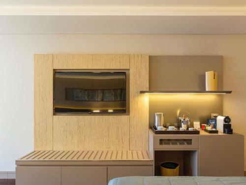 a room with a kitchen with a counter and a counter top at Palladio Hotel Buenos Aires - MGallery Collection in Buenos Aires
