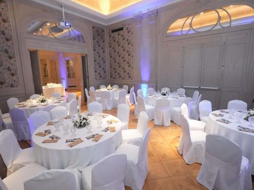 a banquet hall with white tables and white chairs at Palladio Hotel Buenos Aires - MGallery Collection in Buenos Aires
