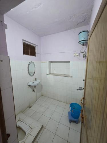 a bathroom with a blue toilet and a sink at Sharib House in Ajmer