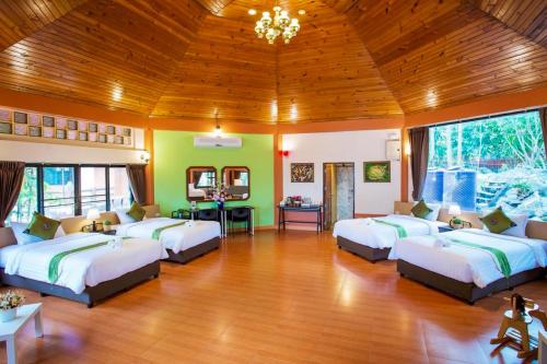 a bedroom with four beds in a room at Bhumisiri Hill Khaoyai in Ban Tha Chang