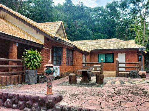 a house with a fire hydrant in front of it at Bhumisiri Hill Khaoyai in Ban Tha Chang
