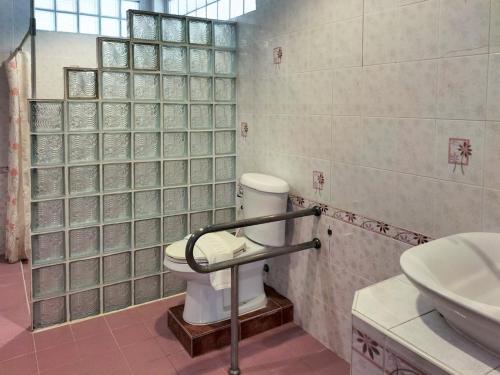 a bathroom with a toilet and a sink at Bhumisiri Hill Khaoyai in Ban Tha Chang