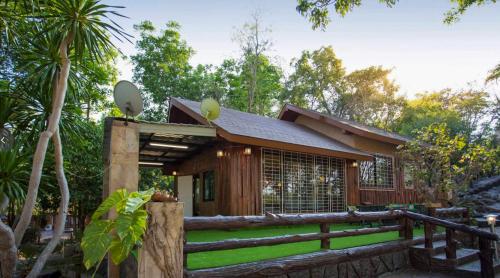 a small house with a fence in front of it at Bhumisiri Hill Khaoyai in Ban Tha Chang