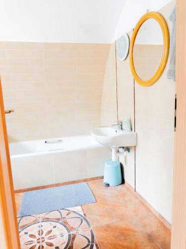 a bathroom with a sink and a mirror at Modern stone house in Balatonfüred with jacuzzi in Balatonfüred