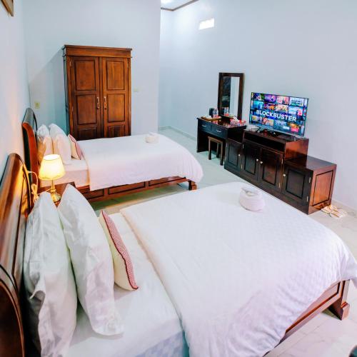 Ένα ή περισσότερα κρεβάτια σε δωμάτιο στο Martin Anugrah Hotel & Restaurant