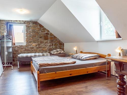 a bedroom with two beds in a attic at Modern stone house in Balatonfüred with jacuzzi in Balatonfüred
